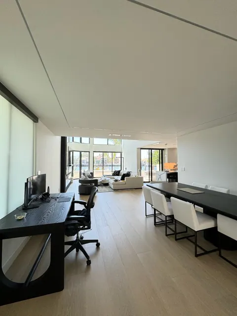 Dining and workspace zone on wide plank flooring