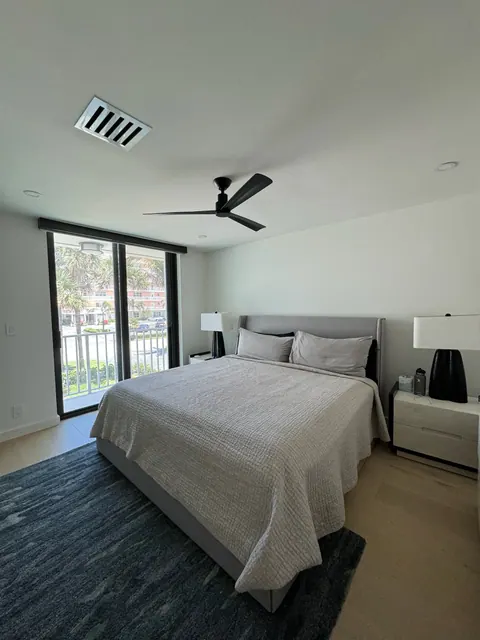 Guest bedroom with light plank flooring