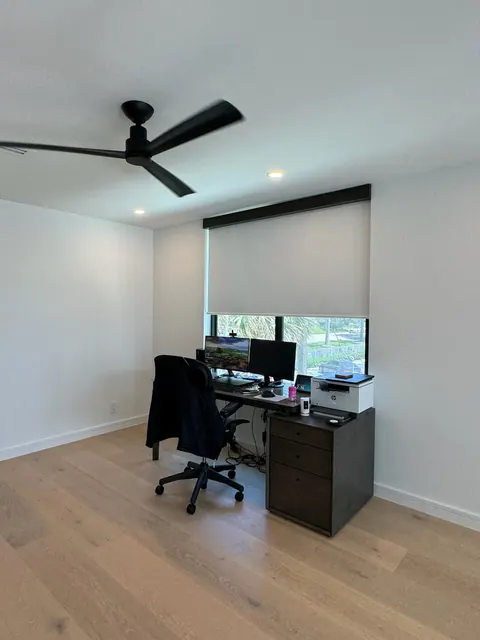 Home office with wide plank flooring