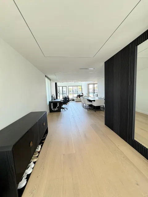 Long view across the main level showing continuous wide plank flooring