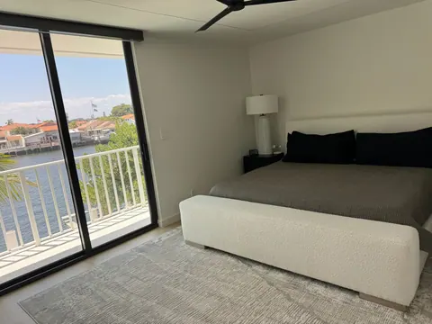 Primary bedroom floor beside sliding doors to the balcony